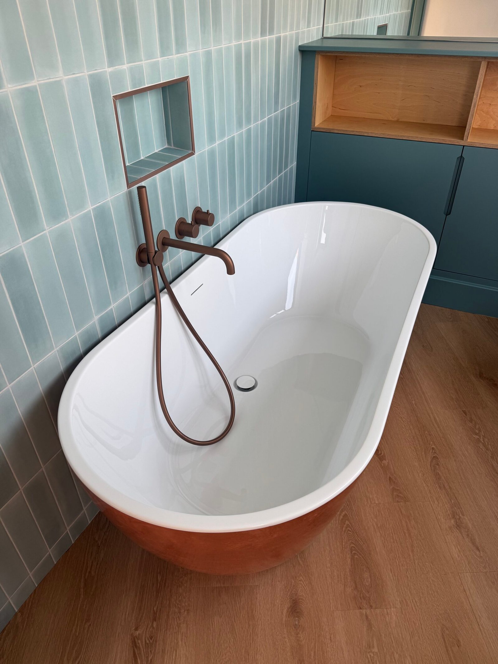 Freestanding white bath with contemporary wall-mounted tap