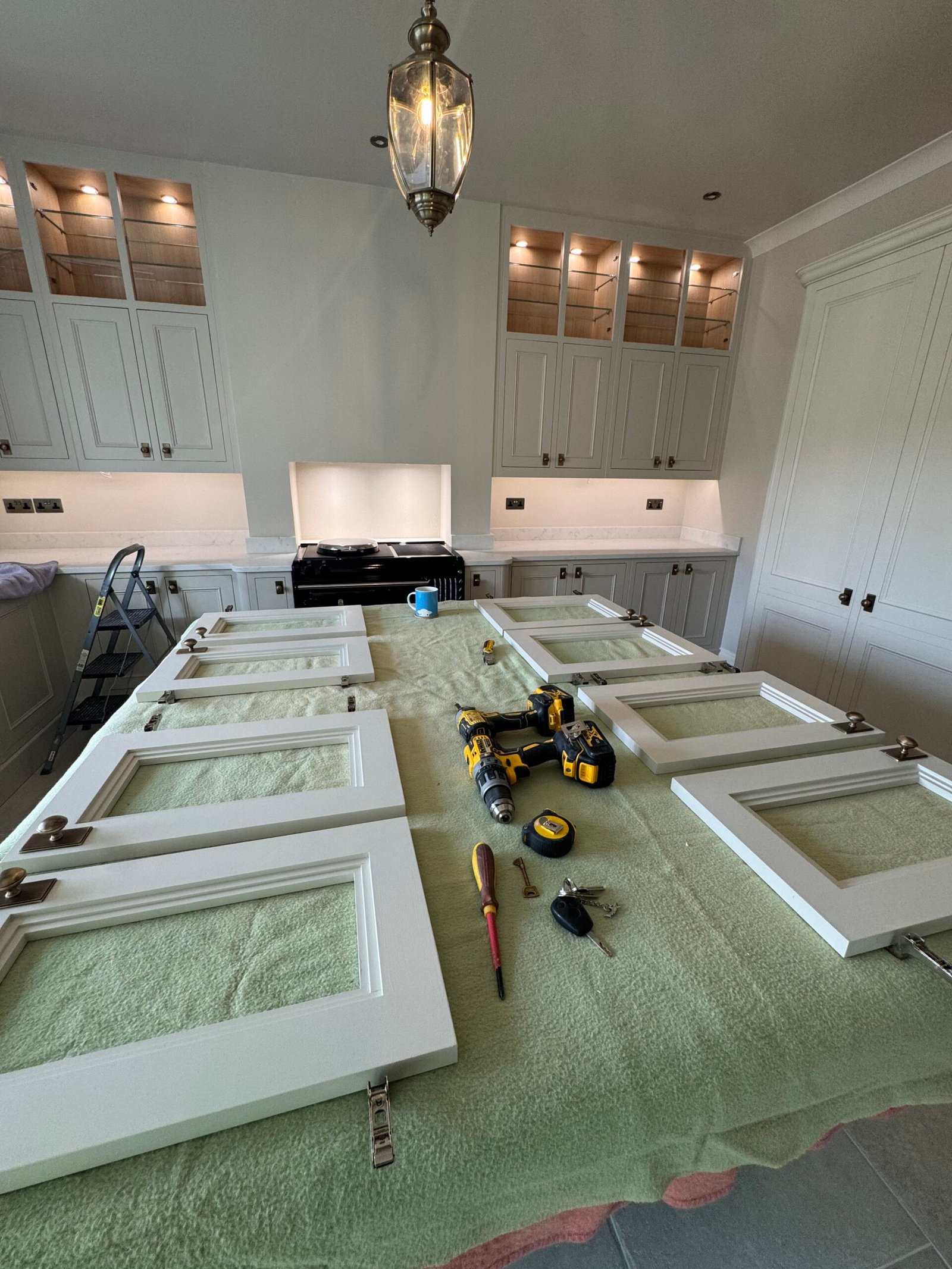 Close-up of kitchen cabinet doors and tools during installation
